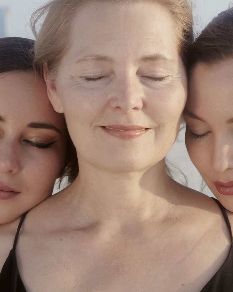 two women with their eyes closed and their eyes closed