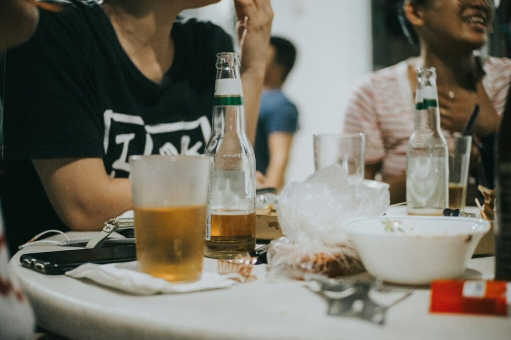 a group of people sitting around a table with drinks